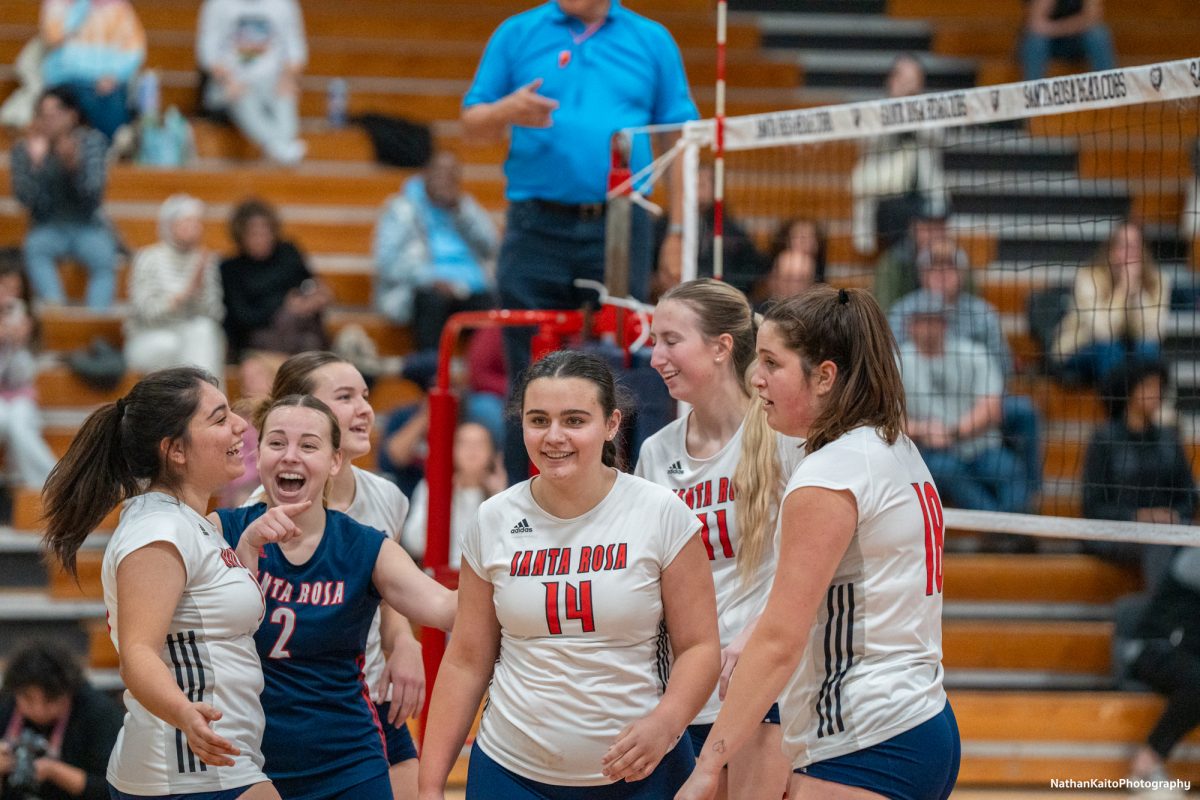 Santa Rosa’s Jaiden Brooner and Stephanie Melendez laugh with Natalie Walsh during a break in the set against San Joaquin Delta at Haehl Pavilion on Friday, Nov. 15, 2024.