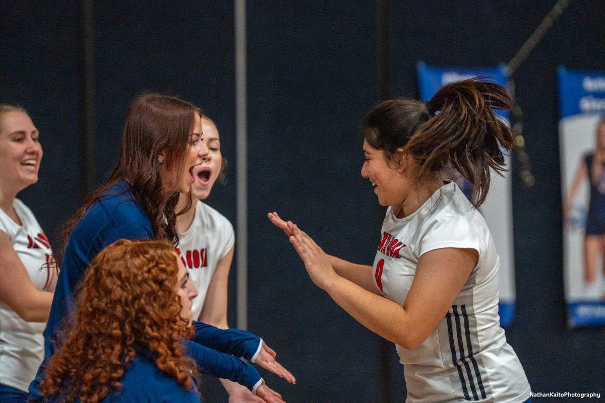 Bear Cubs’ red shirt Jillian Mefferd high-fives outside hitter Stephanie Melendez as she comes off the court against San Joaquin Delta at Haehl Pavilion on Friday, Nov. 15, 2024.