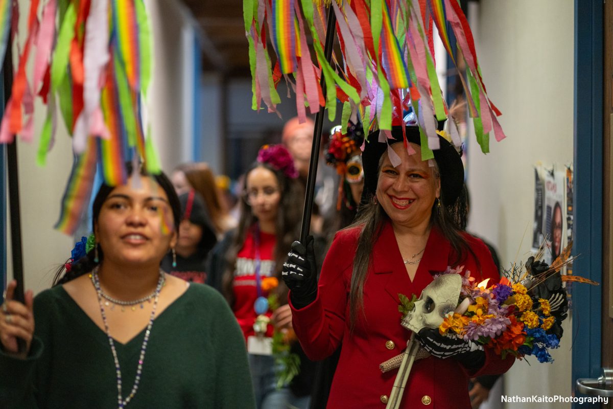 Deborah Virgen leads the procession through Emeritus Hall for the Dia De Muertos event on Wednesday, Oct. 23, 2024.