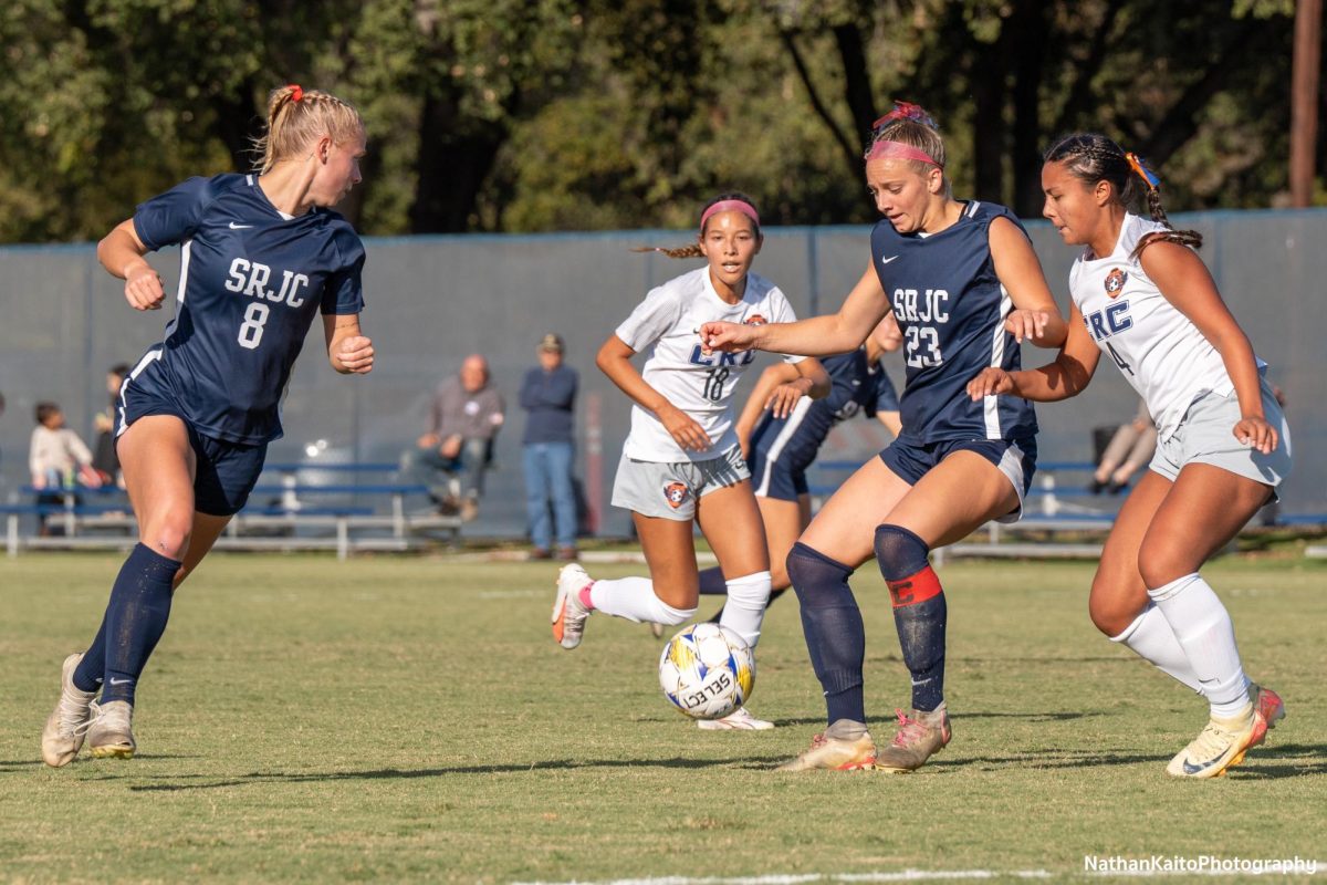 Bear Cubs’ forward Shae Dougherty holds up the ball as forward Taylor Gandy makes an overlapping run against Cosumnes River at home on Tuesday, Oct. 29, 2024.