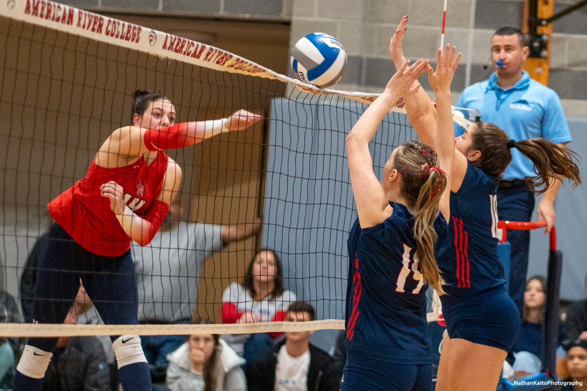 Santa Rosa’s middle blocker Eve Mendoza and middle/opposite Luka Amand rise to block against American River at the American River gym on Tuesday, Nov. 26. 