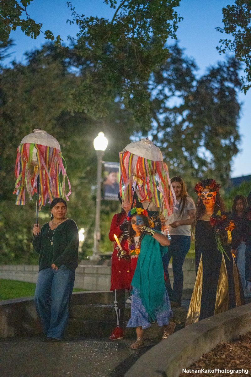 The procession makes their way out of the Doyle Library after visiting the final altar decorated inside on Wednesday, Oct. 23, 2024.