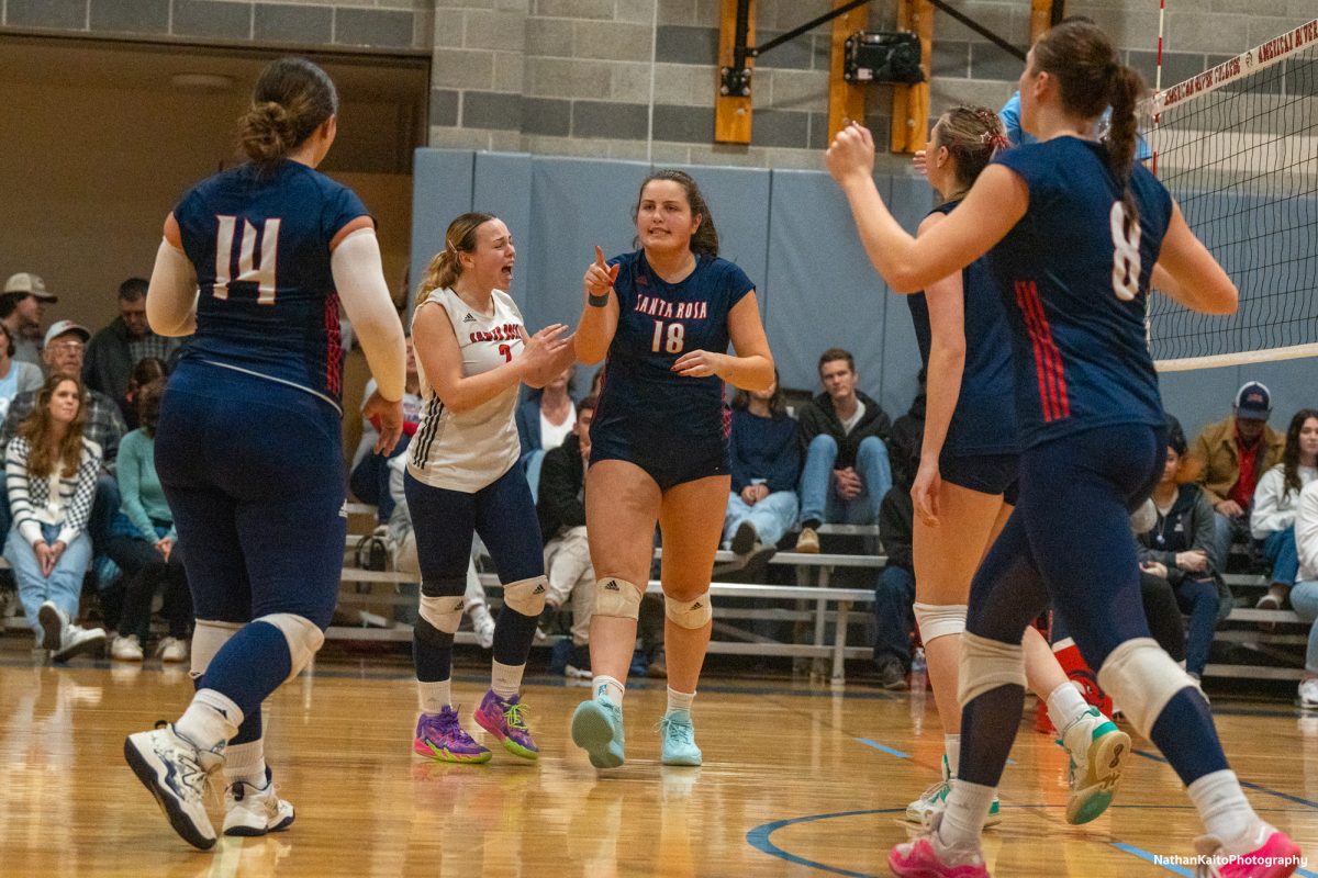 Bear Cubs’ middle/opposite Luka Amand points at setter Natalie Walsh after scoring a point that was set up by Walsh against American River at the American River gym on Tuesday, Nov. 26. 