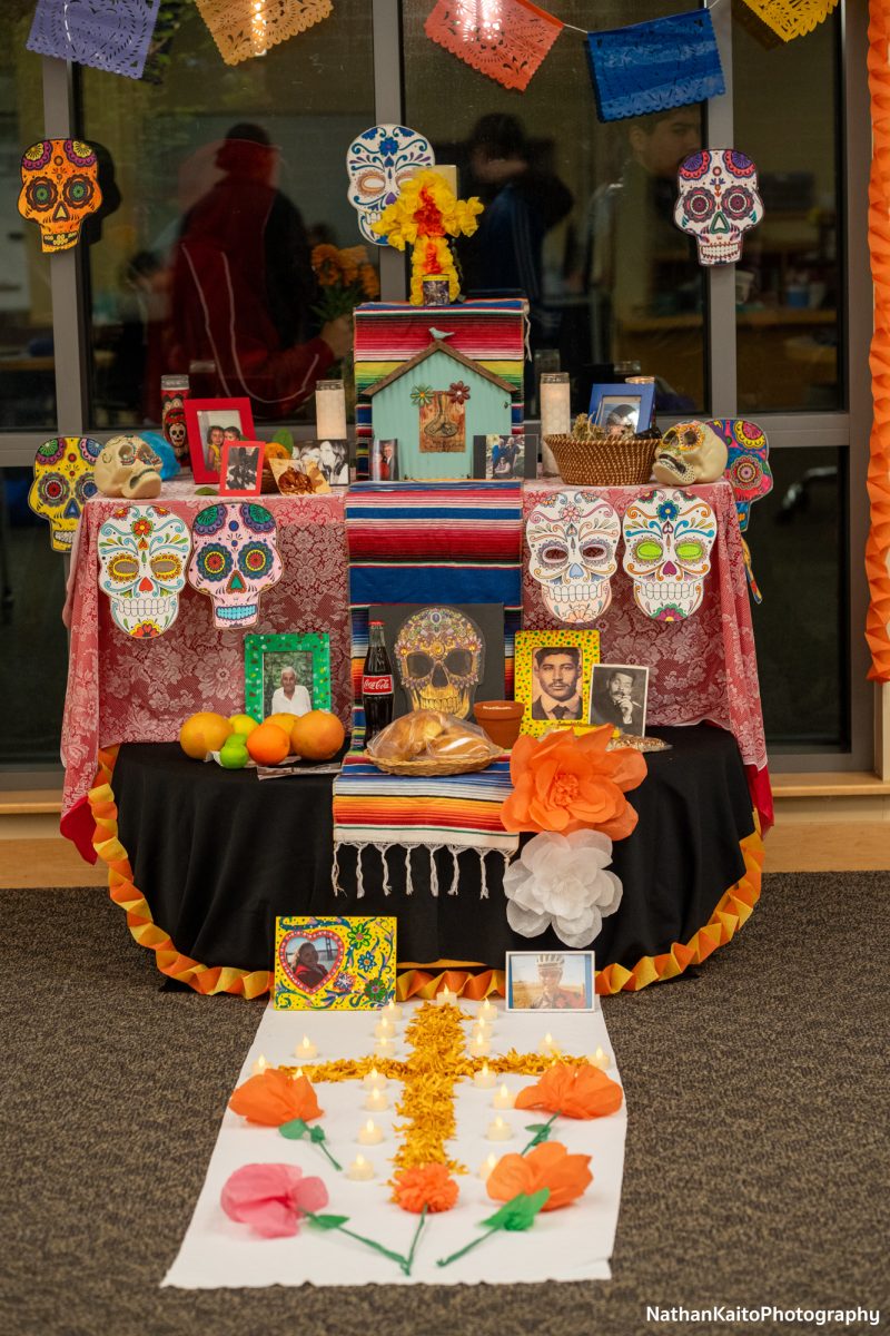 An ofrenda placed inside of the Tutor Center is visited during the procession at the Dia De Muertos festivities at the Bertolini Student Center on Wednesday, Oct. 23, 2024.