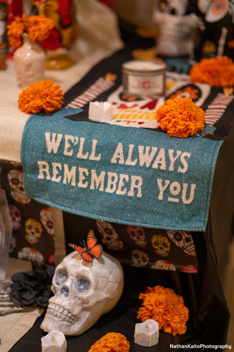 An ofrenda placed in the faculty offices of Newman Auditorium is visited during the procession at the Dia De Muertos celebration at the Bertolini Student Center on Wednesday, Oct. 23, 2024.