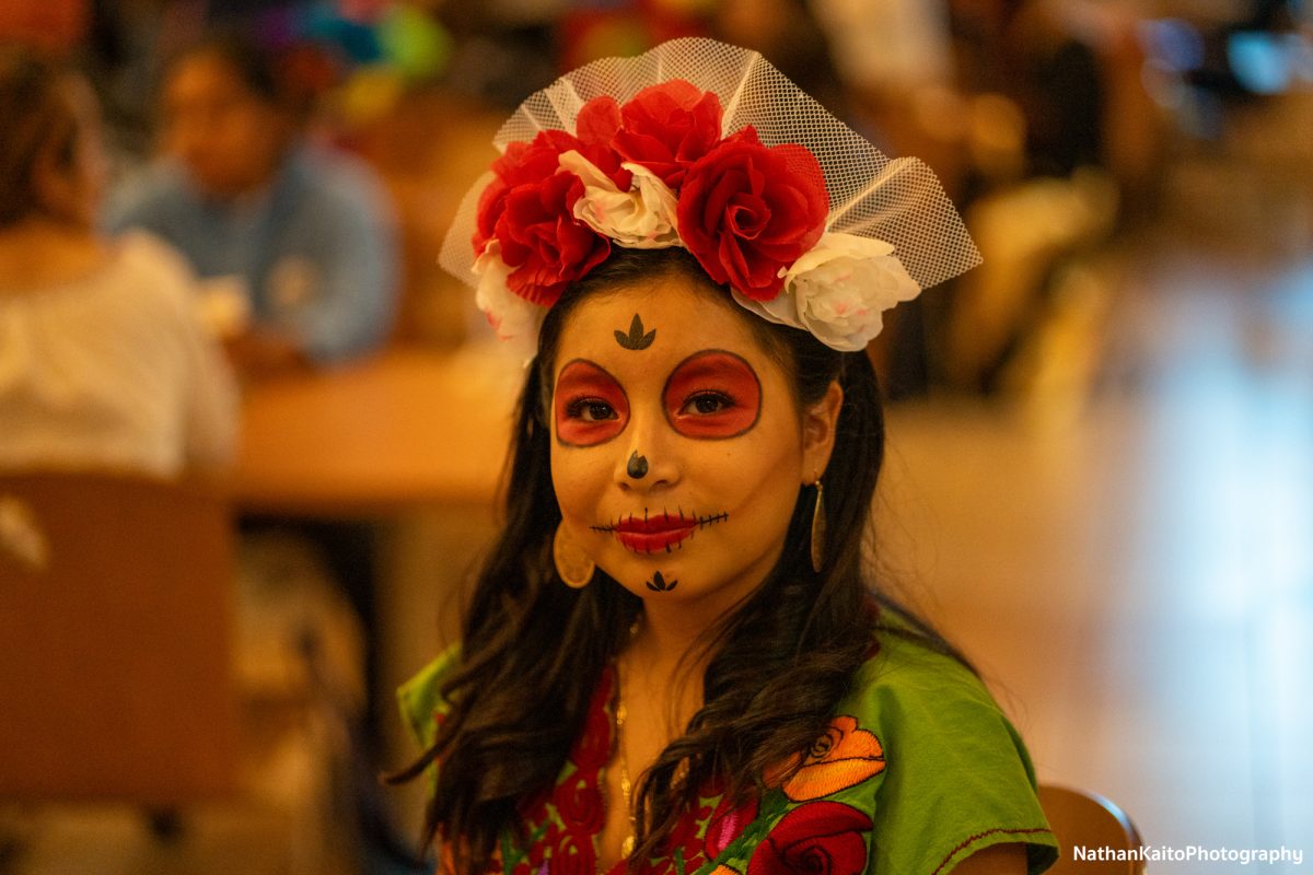 Vanessa adorns traditional Dia De Los Muertos clothes and face paint at the Dia De Los Muertos event at the Bertolini Student Center  on Wednesday, Oct. 23, 2024.