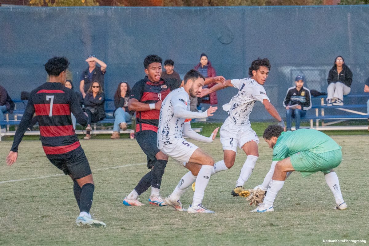 Bear Cubs’ midfielder Kleber Maldonado’s effort is scooped up by Cosumnes River’s Nicholas Molinari at home against Cosumnes River on Tuesday, Nov. 12, 2024. 