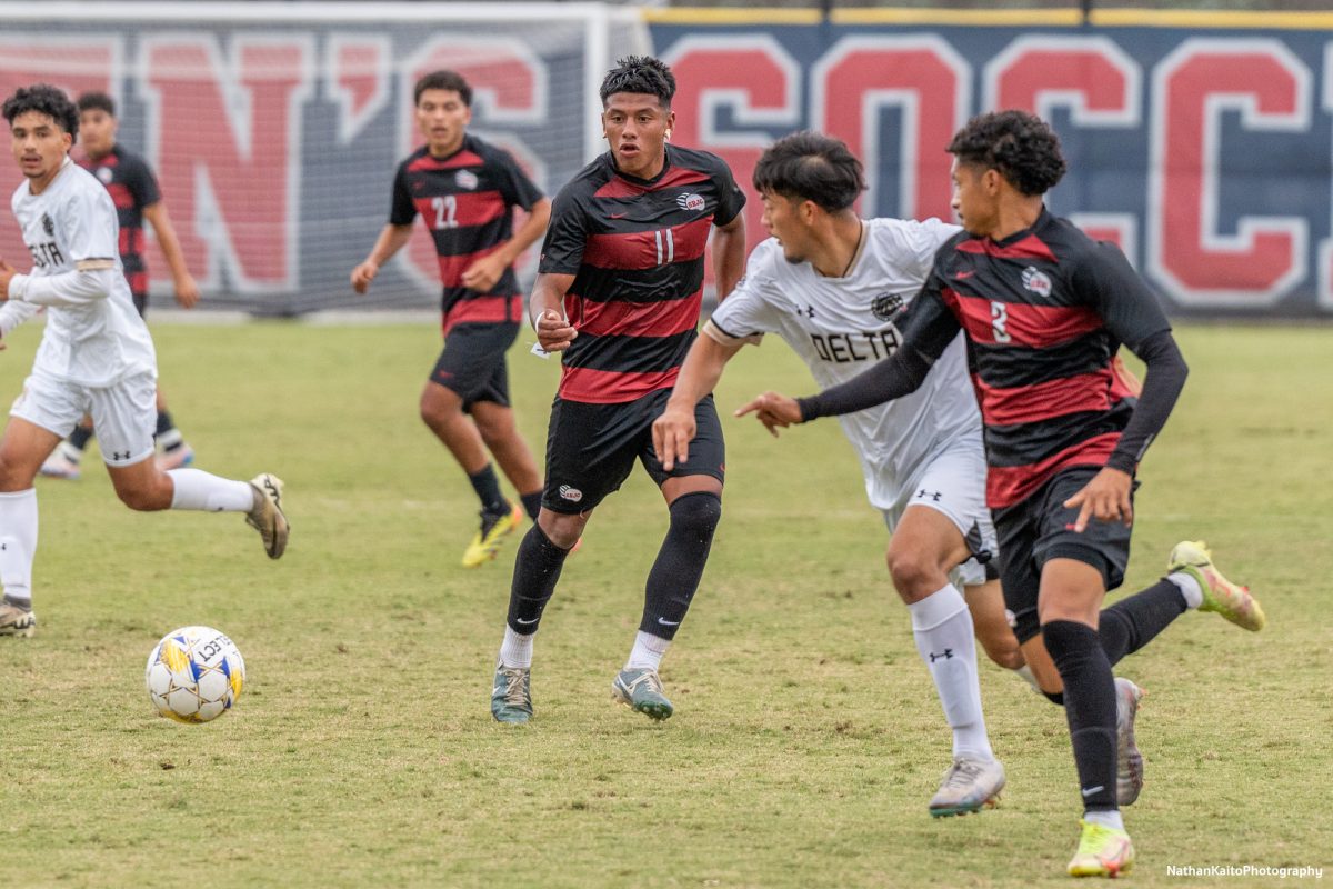 Bear Cubs’ midfielder Kleber Maldonado plays in defender, Raffino Landford who made an overlapping run against San Joaquin Delta at Sypher Soccer Field on Friday, Nov. 1st, 2024