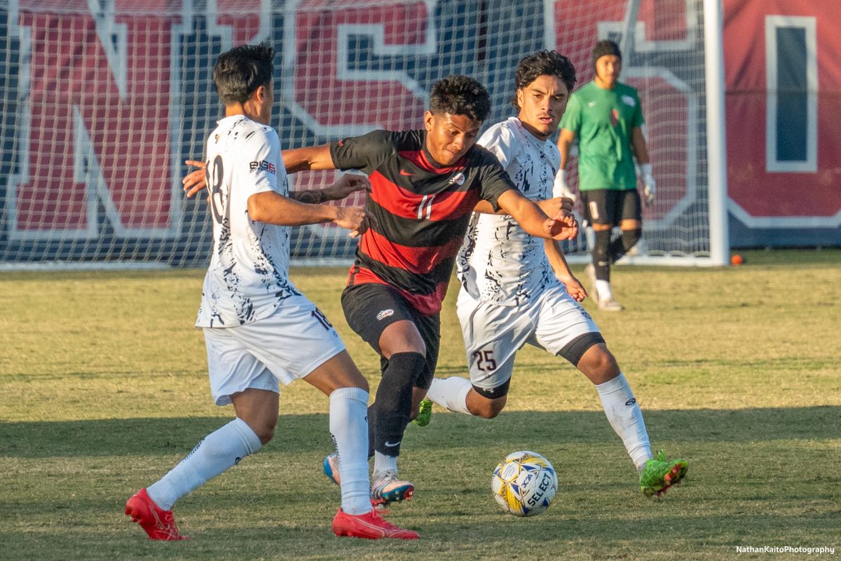 Bear Cubs’ midfielder Kleber Maldonado surges forward as Cosumnes River’s Joaquin Luna and Ezekiel Cruz mark him at home against Cosumnes River on Tuesday, Nov. 12, 2024. 