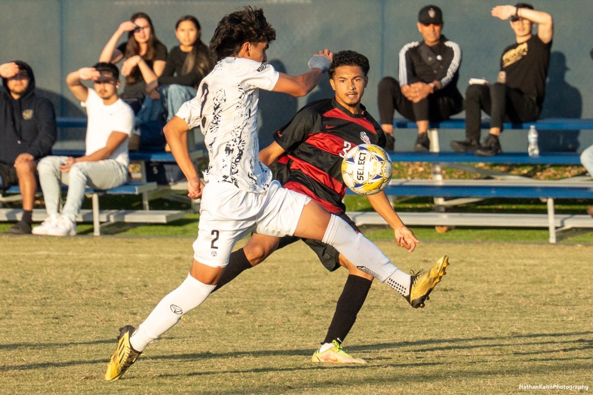 Santa Rosa’s defender Raffino Landford whips in a cross that evades Cosumnes River defender Christian Brenes at home against Cosumnes River on Tuesday, Nov. 12, 2024.