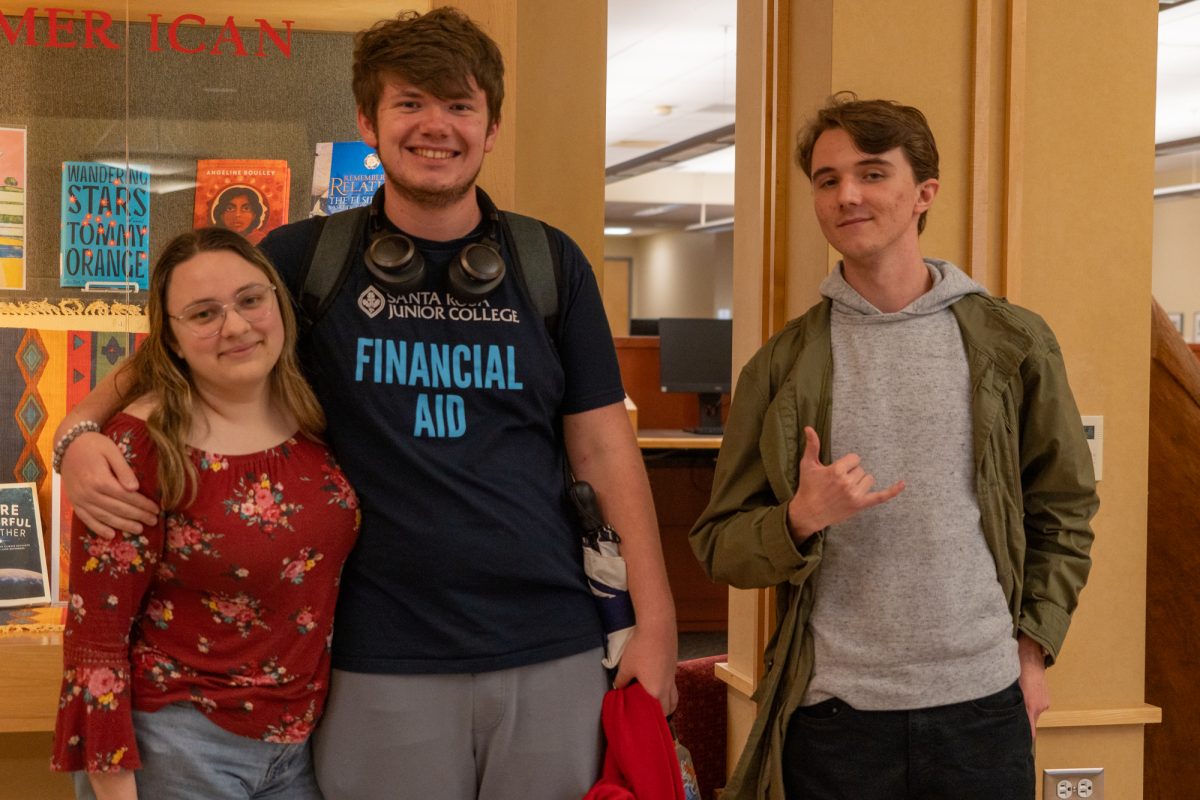 Library assistants Isabella Tickner (left) Luke Cox (center) and Zachary Hammond (right) are all smiles near Frank P. Doyle Library on Thursday, Nov. 14, 2024.