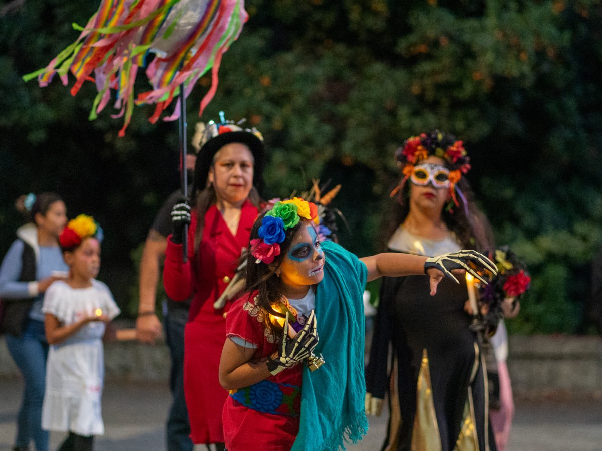 The procession makes its way to Newman Auditorium to view the first of many ofrendas during the Dia De Muertos celebration at the Santa Rosa campus on Wednesday, Oct. 23, 2024.