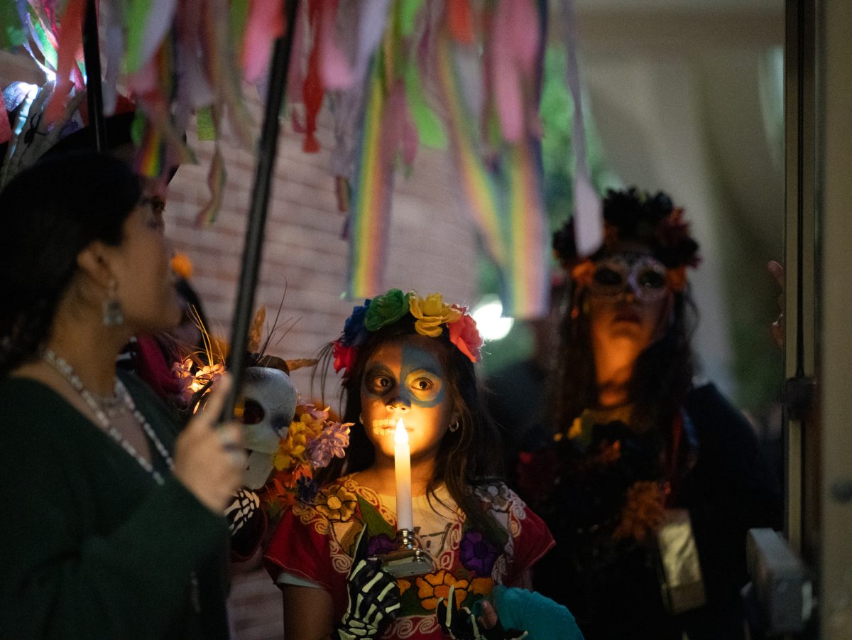 Attendees wait outside of the faculty offices in Newman Auditorium to view the first of many ofrendas during the Dia De Muertos celebration at the Santa Rosa campus on Wednesday, Oct. 23, 2024.