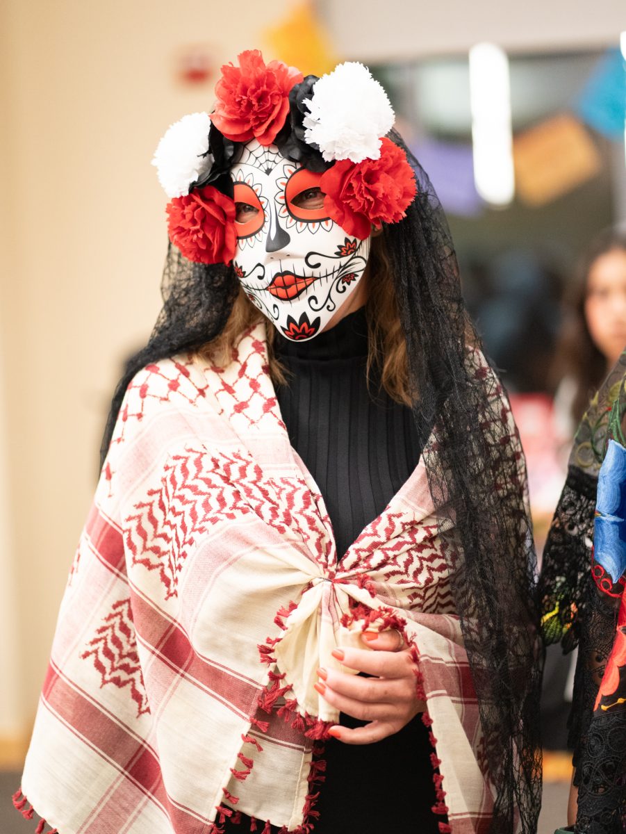 Attendees dressed in full Catrin/Catrina for the Dia De Muertos celebration in the Bertolini Student Center on Wednesday, Oct. 23, 2024.