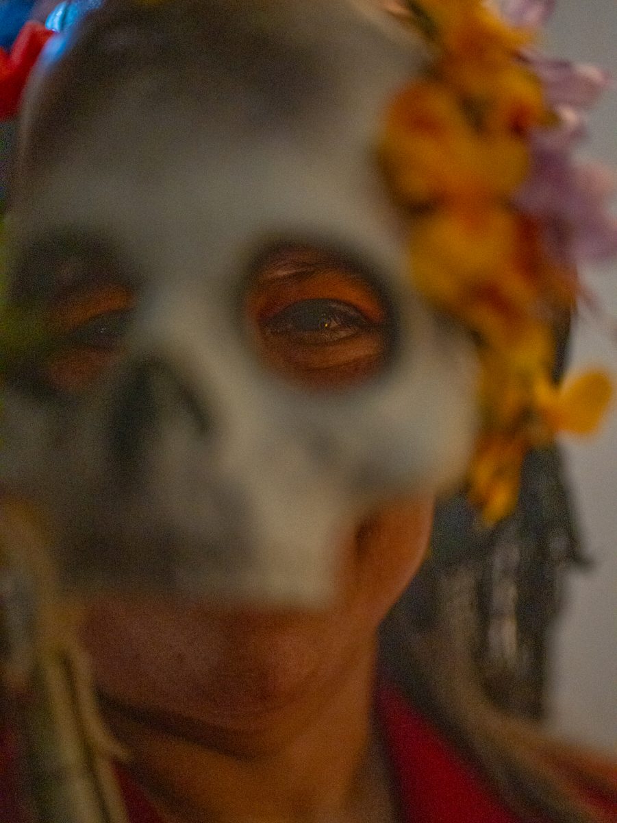 Deborah Virgen shows off her handmade mask during the Dia De Muertos celebration at the Bertolini Student Center on Wednesday, Oct. 23, 2024.