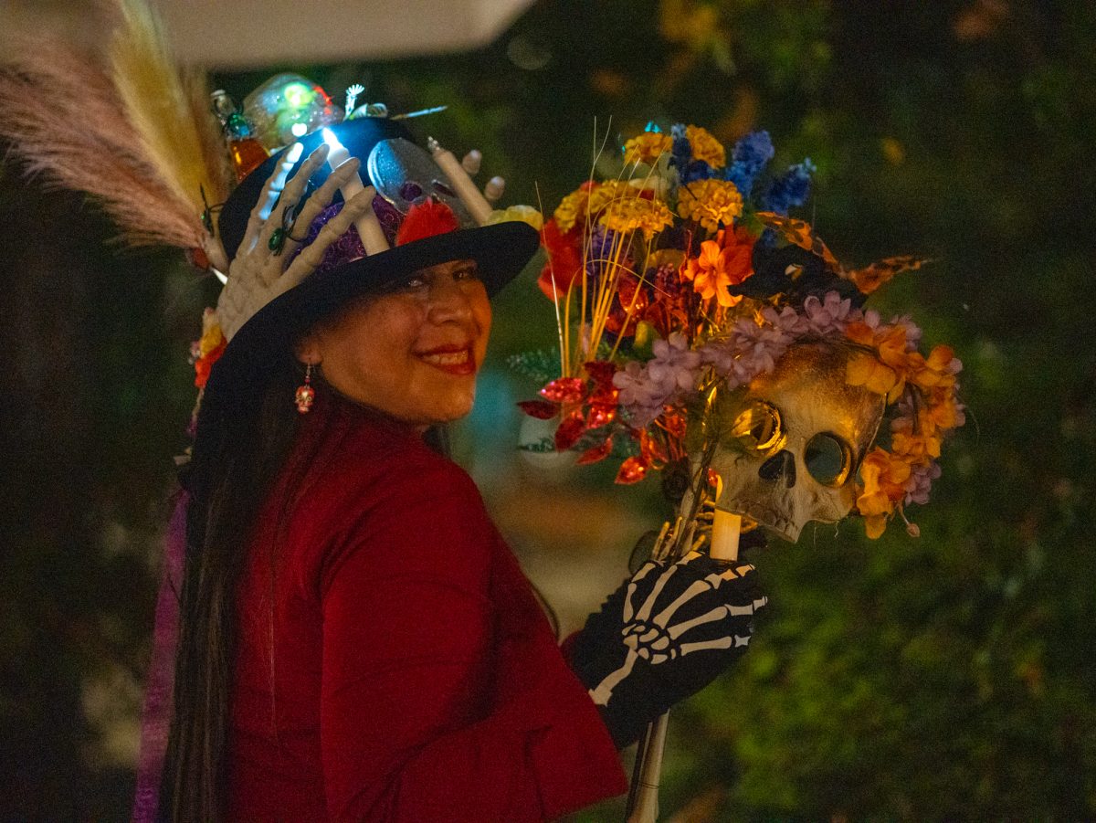 Deborah Virgen shows off her handmade creations for the Dia De Muertos celebration at the Bertolini Student Center on Wednesday, Oct. 23, 2024.