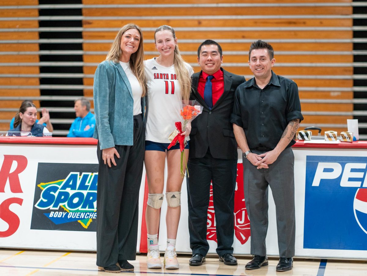 Middle/opposite Kiana Walker poses with head coach Ally Sather, left, and assistant coaches, Tommy Wong, center, and Ryan Hughes, right, ahead of Sophomore Night at home against San Joaquin Delta on Friday, Nov. 15, 2024.