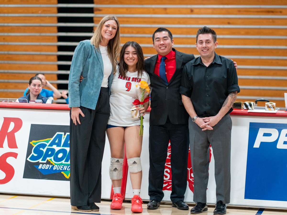 Outside hitter Stephanie Melendez poses with head coach Ally Sather, left, and assistant coaches, Tommy Wong, center, and Ryan Hughes, right, ahead of Sophomore Night at home against San Joaquin Delta on Friday, Nov. 15, 2024.