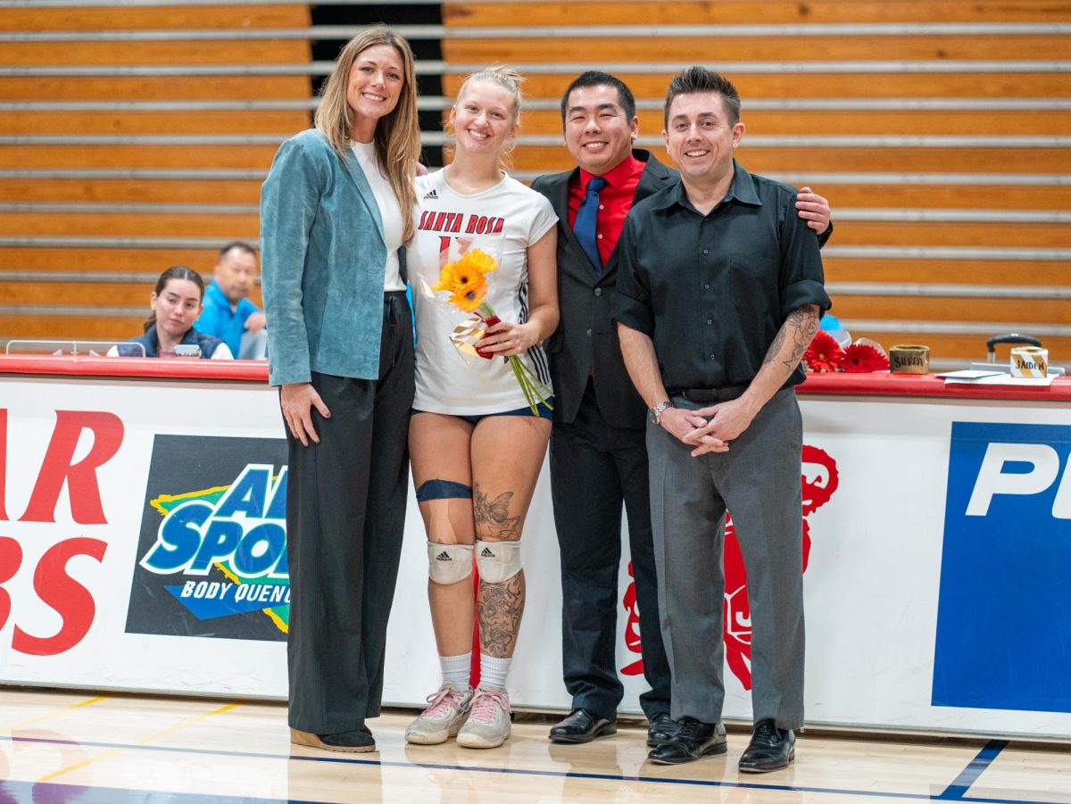 Middle blocker Sarah Thornton poses with head coach Ally Sather, left, and assistant coaches, Tommy Wong, center, and Ryan Hughes, right, ahead of Sophomore Night at home against San Joaquin Delta on Friday, Nov. 15, 2024.