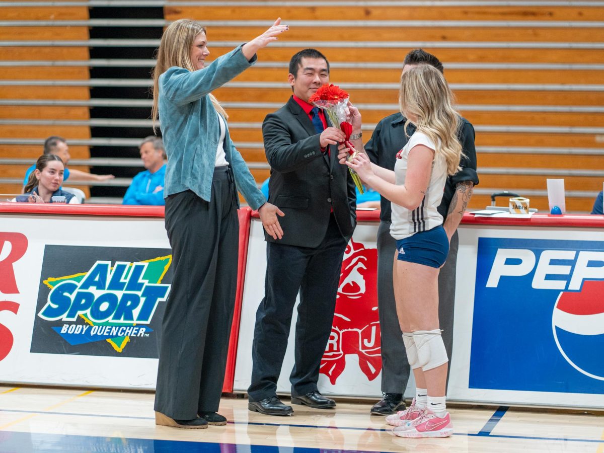 Head coach Ally Sather, left, recognizes setter Sierra Yates-Bruch, right, ahead of Sophomore Night at home against San Joaquin Delta on Friday, Nov. 15, 2024.