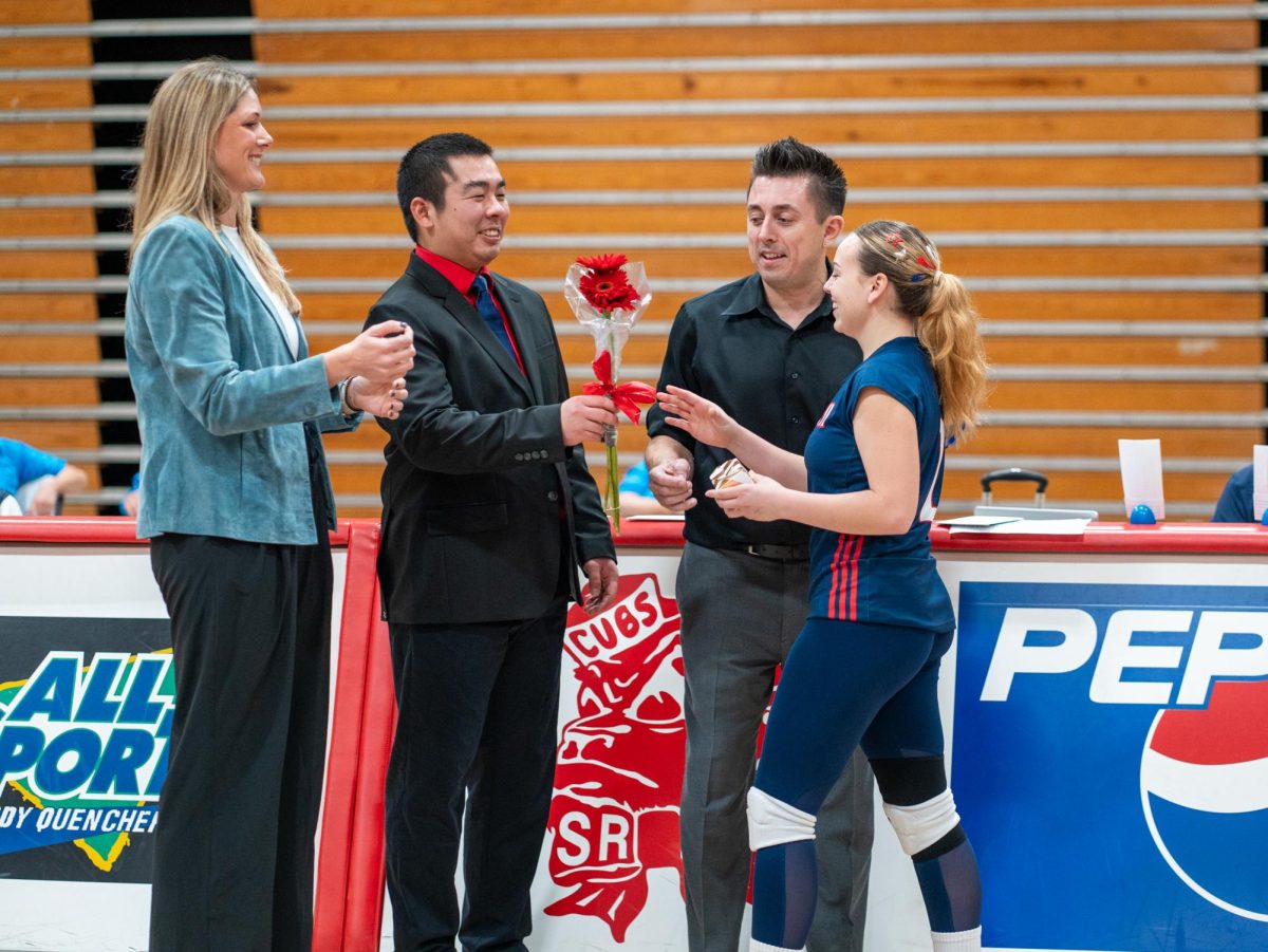 Assistant coach Tommy Wong, center, recognizes defensive specialist Jaiden Brooner, right, ahead of Sophomore Night at home against San Joaquin Delta on Friday, Nov. 15, 2024.