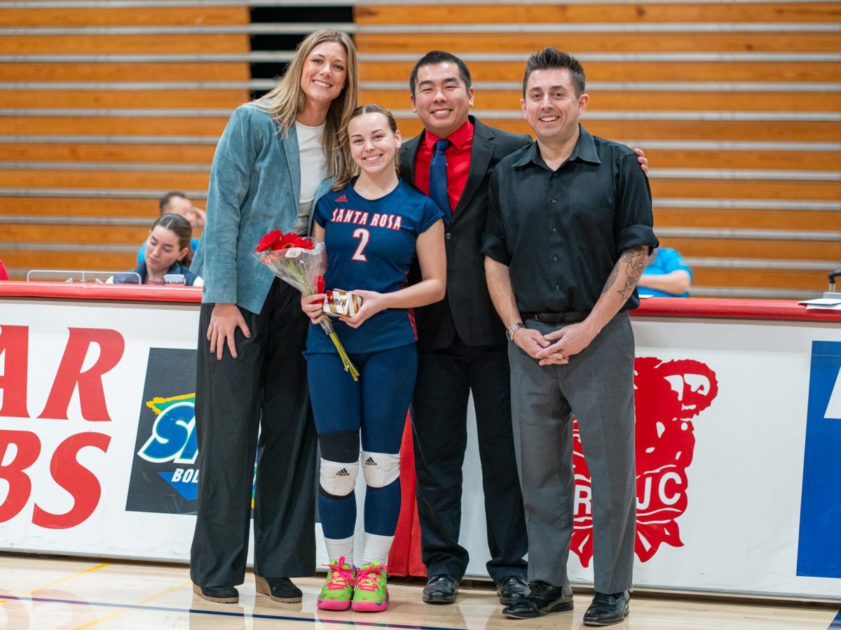 Defensive specialist Jaiden Brooner poses with head coach Ally Sather, left, and assistant coaches, Tommy Wong, center, and Ryan Hughes, right, ahead of Sophomore Night at home against San Joaquin Delta on Friday, Nov. 15, 2024.