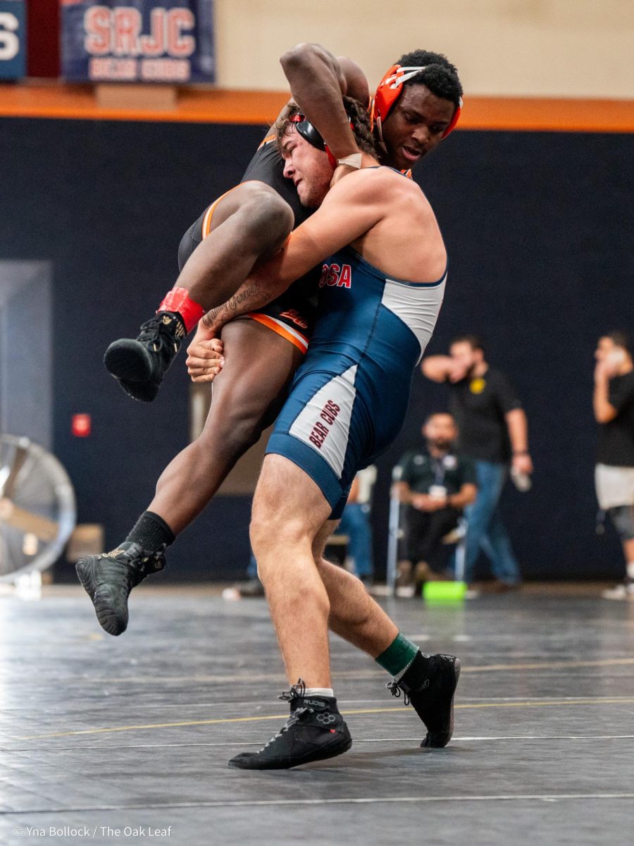 Bear Cub Joe Ellis (197) prepare to throw Lassen's Chris Wells into the mat in the quarterfinals of the CCCAA Norcal Regional Championships in Haehl Pavilion on Saturday, Dec. 7. Ellis wins by fall.