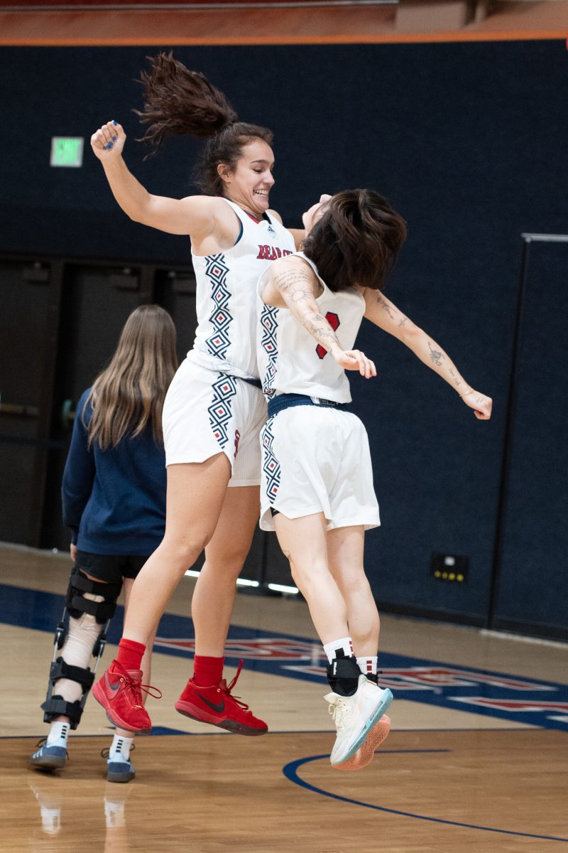 Bear Cubs guard/forward Ivy Gonzalez, left, chest bumps guard Cele Urzua, right, before their match against College of San Mateo at Haehl Pavilion on Friday, Dec. 6, 2024.