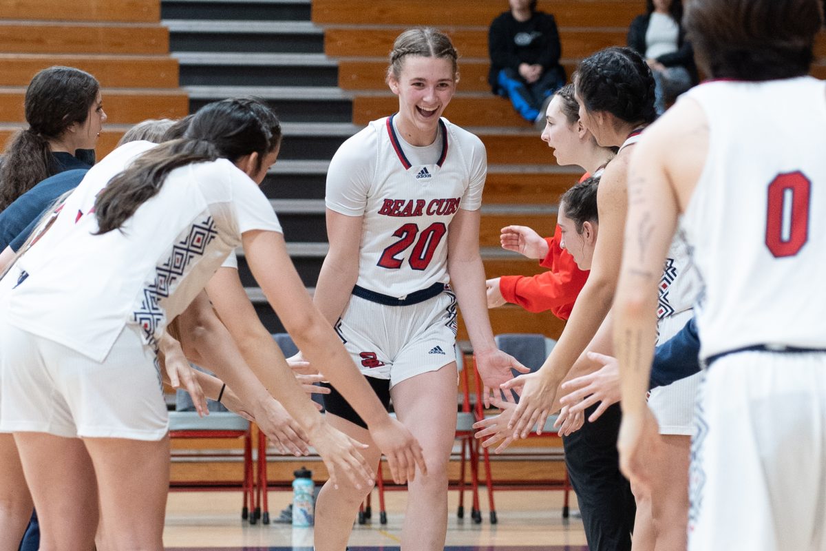 Bear Cubs forward Sydney Martin receives a slew of high-fives from her teammates ahead their match against College of San Mateo at Haehl Pavilion on Friday, Dec. 6, 2024.