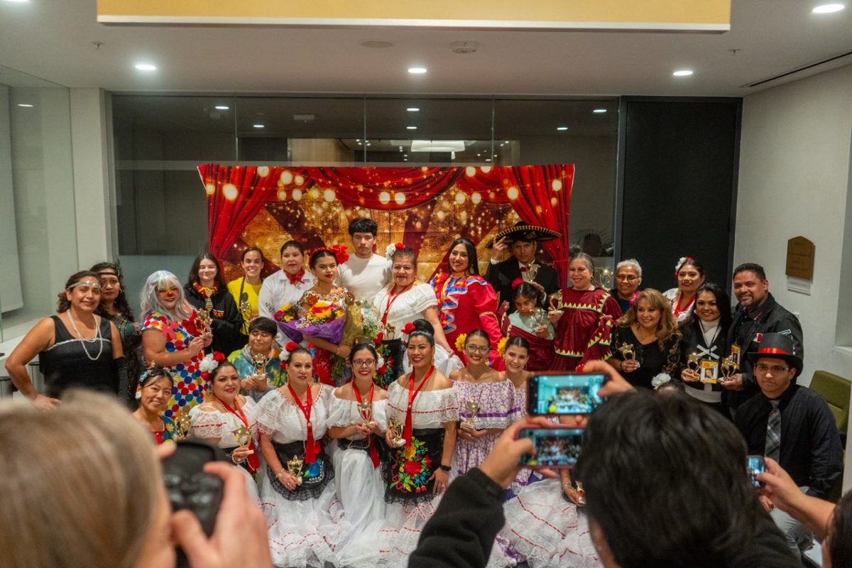 Participants gather in the Burbank Auditorium lobby to take photos and celebrate a night of talent and community at La Carpa on Nov. 22, 2024.