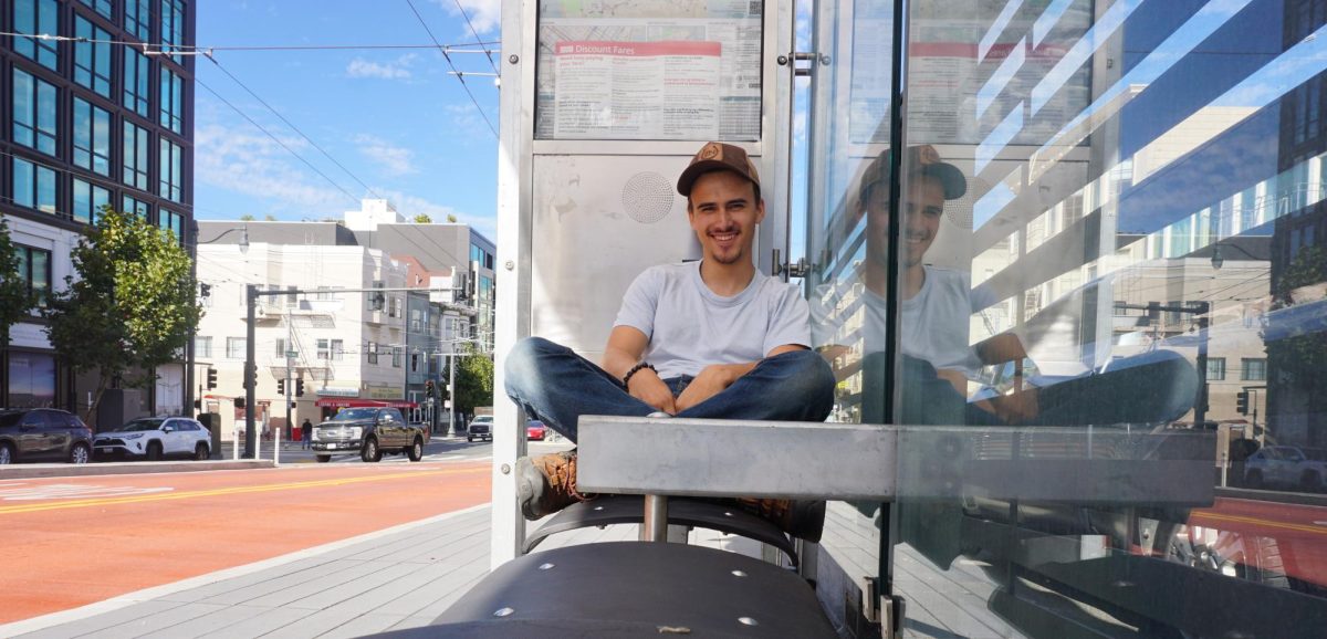 Henry Fliflet waits after missing the first bus back home in San Francisco on Oct. 25, 2024.