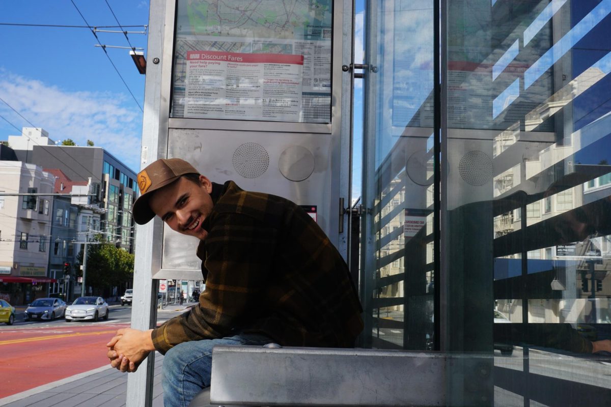 Henry Fliflet waits after missing the first bus back home in San Francisco on Oct. 25, 2024.