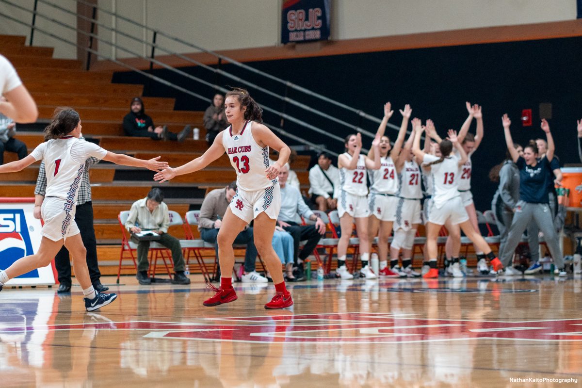 Bear Cubs’ guard/forward Ivy Gonzales celebrates with guard, Lindsey Arellano, in front of an ecstatic bench after sinking a three-pointer against Butte at Haehl Pavilion on Tuesday, Dec. 10, 2024