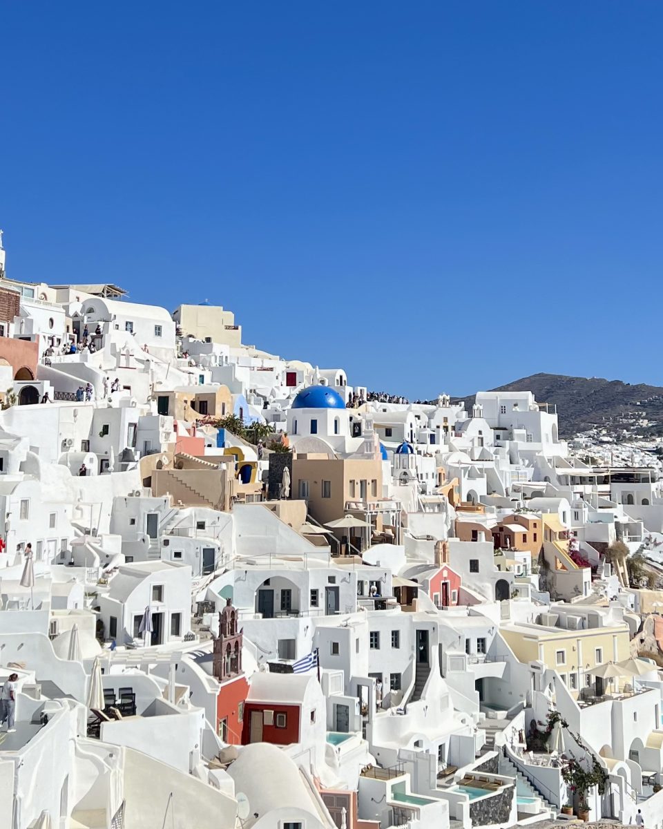 The famous white houses and blue domes of Santorini, Greece.