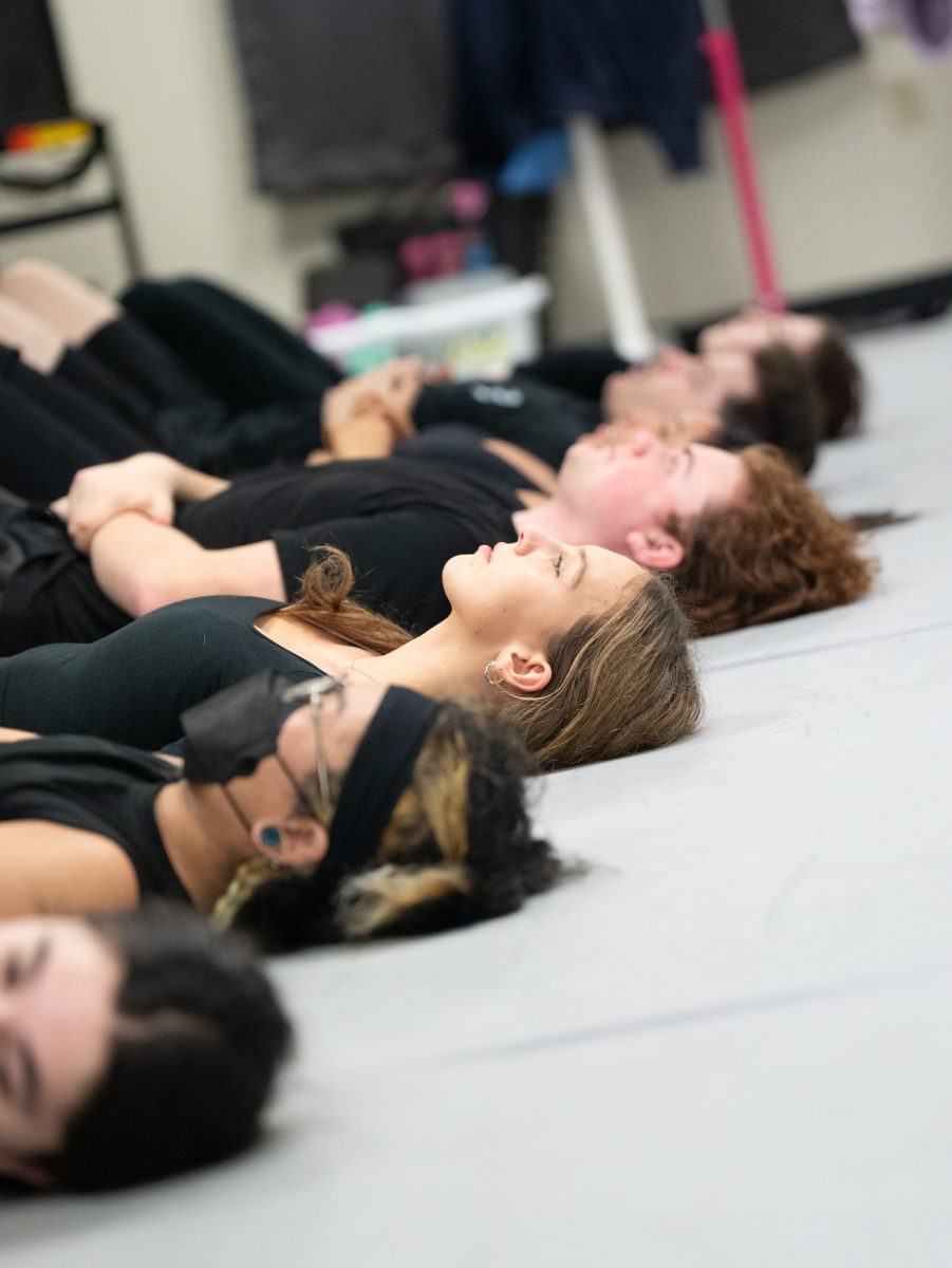 SRJC dance students prepare to slide across the dance floor in the Analy Village dance studio for a choreographed piece in Fall 2024.