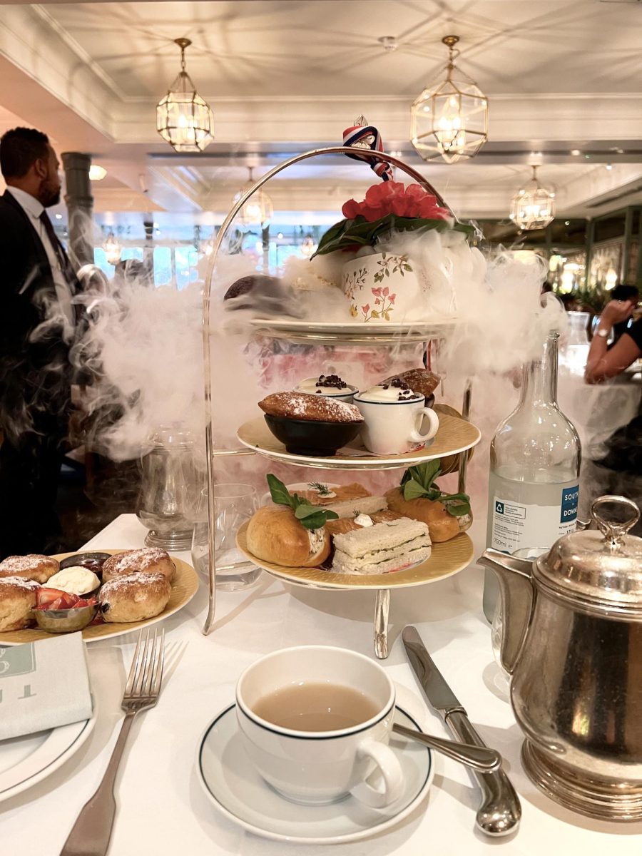 Dry ice cascades over an impressive three tiered treats stand during afternoon tea service at the Ivy, Chelsea Garden in London.