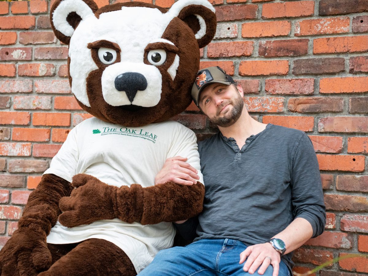 Oak Leaf reporter Marty Lees sits cozy with SRJC mascot Rosco the Bear on Nov. 18, 2024.