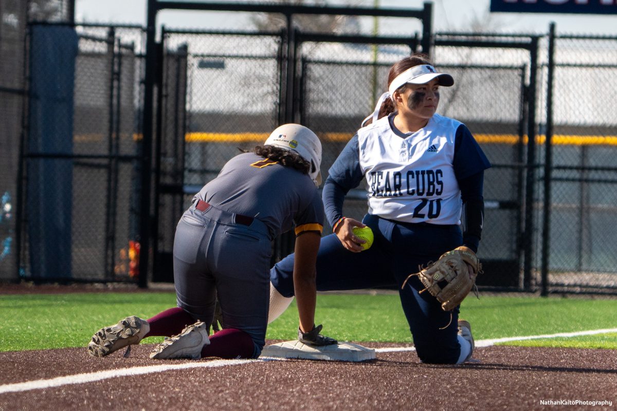 The Bear Cubs’ infielder Gabby Schenone kneels over third base with the ball as a Hartnell player just arrives at Marv Mayes Softball Field on Friday, Jan. 24th, 2025