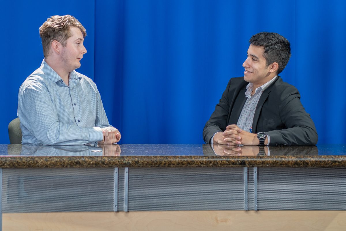 Oak Leaf editors, and election day coverage hosts, Oliver Kindt and Salvador Sandoval-Garduno exchange words before going live, in the studio in Frank P. Doyle Library on Tuesday, Nov. 5, 2024.