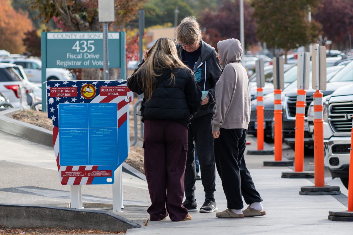 Voters organize themselves prior to the polls opening at the Registrar of Voters in Santa Rosa on Tuesday, Nov. 5, 2024.