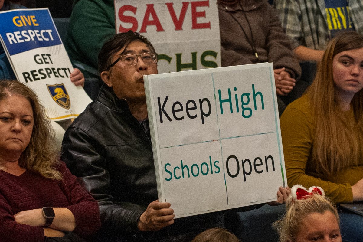 An attendee at a Santa Rosa school district board meeting protests the possible closure of select schools at Santa Rosa City Hall on Wednesday Dec. 11, 2024.