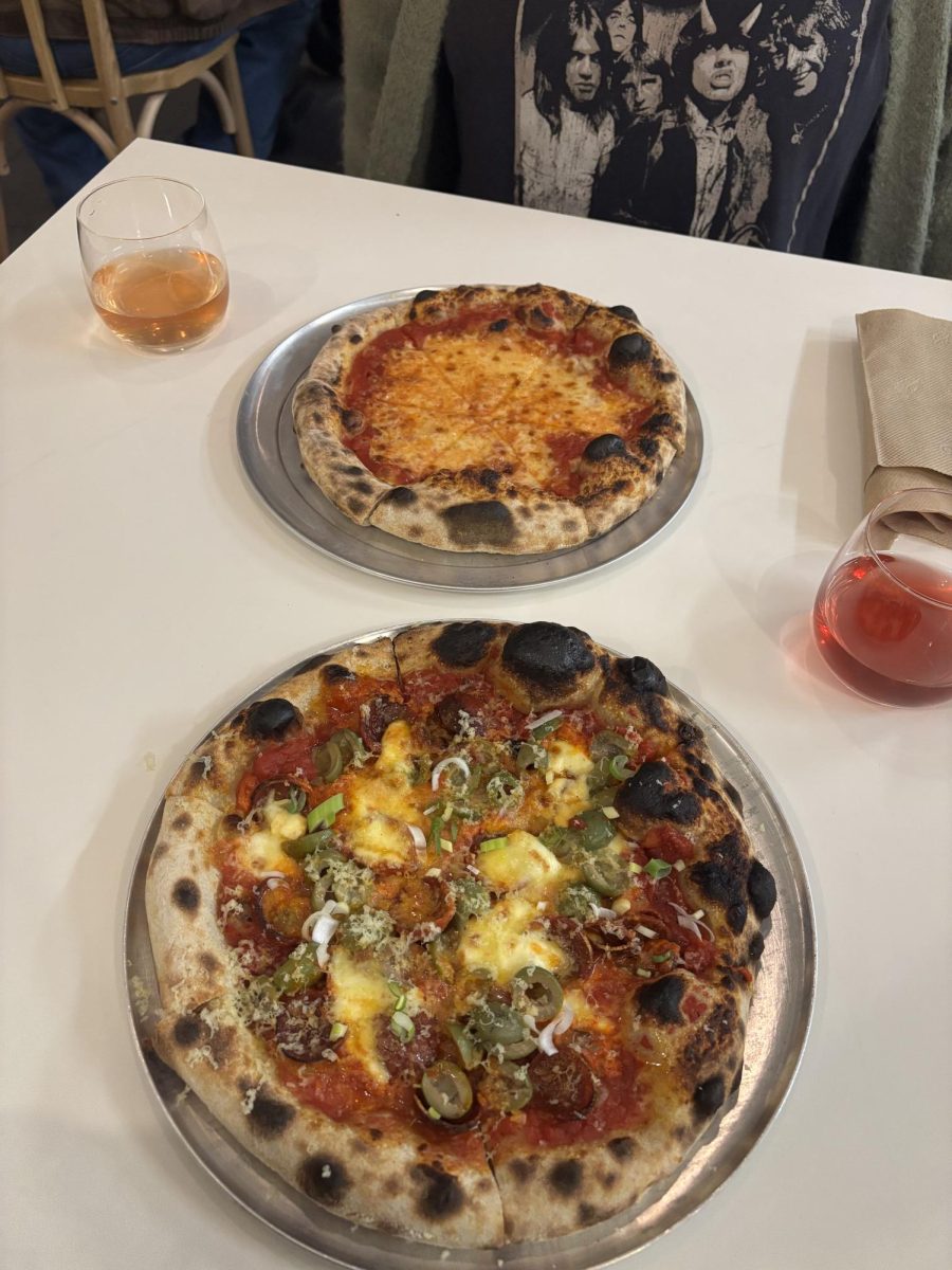 Slow Co Pizza’s “Pep in Your Step” and “The Bird” personal pizzas, served with two glasses of natural wine, in Slow Co’s flagship storefront in Cotati, California, on Tuesday, Jan 14th, 2025.