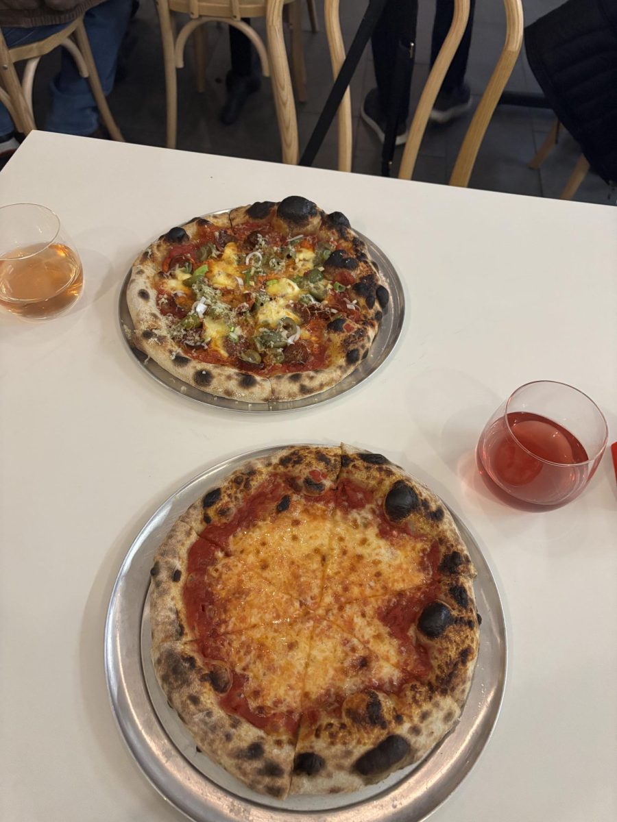 Slow Co Pizza’s “Pep in Your Step” and “The Bird” personal pizzas, served with two glasses of natural wine, in Slow Co’s flagship storefront in Cotati, California, on Tuesday, Jan 14th, 2025.