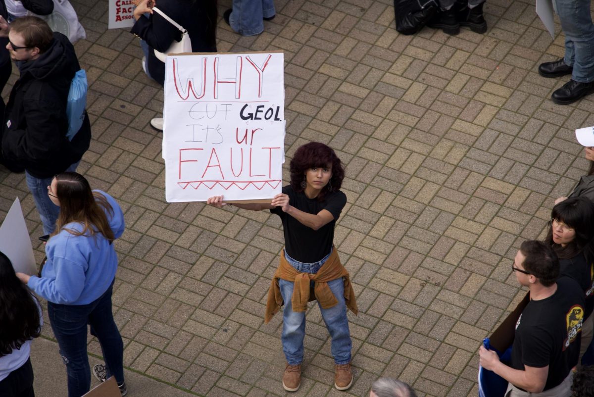 Sonoma State Geology students gathered in matching shirts, chanting "Rock beats scissors" and holding signs during the rally on Thursday, Jan. 30, 2025. 