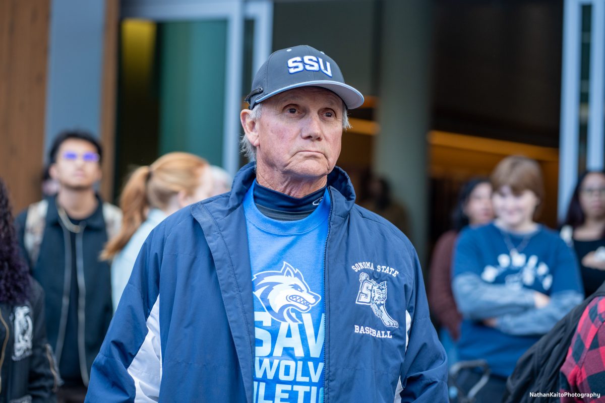 Sonoma State University's assistant baseball coach Dolf Hes looks on as students protest the budget cuts in Rohnert Park on Thursday, Jan. 30, 2025.