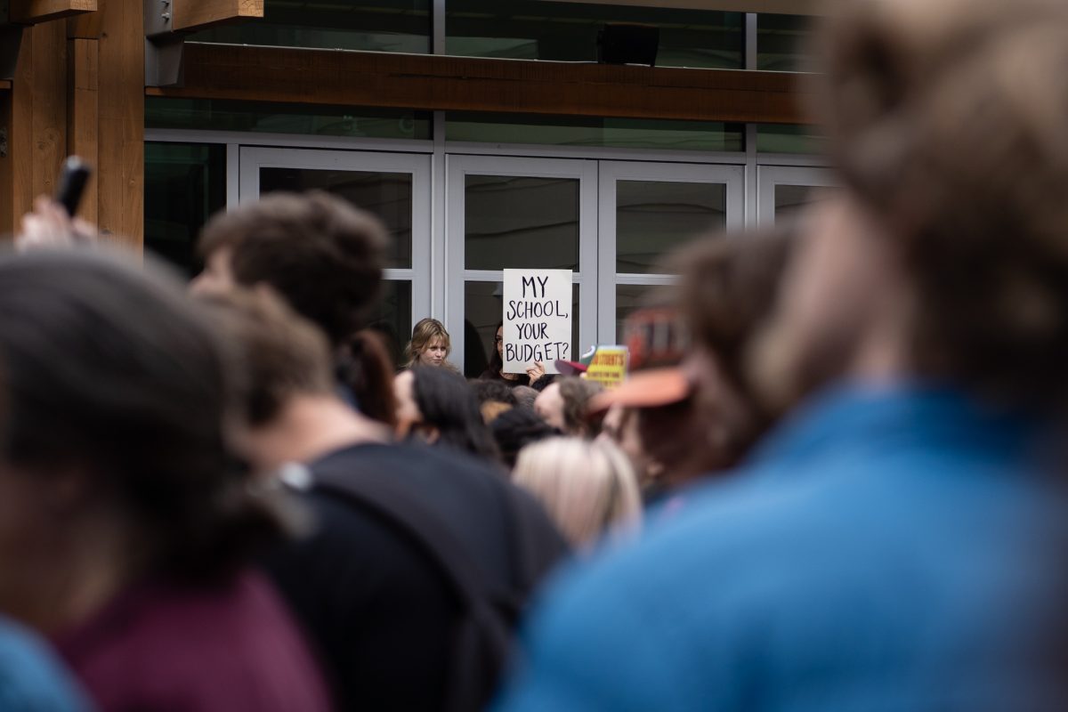 A Sonoma State University student holds up a sign in protest of the Sonoma State University's budget cuts in Rohnert Park on Thursday, Jan. 30, 2025.