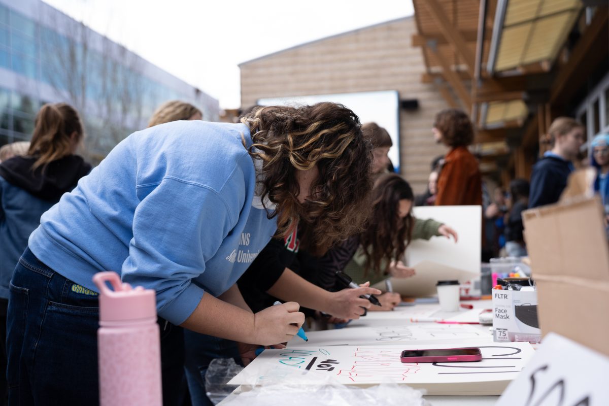 Sonoma State University students making signs in protest of Sonoma State University's budget cuts in Rohnert Park on Thursday, Jan. 30, 2025.