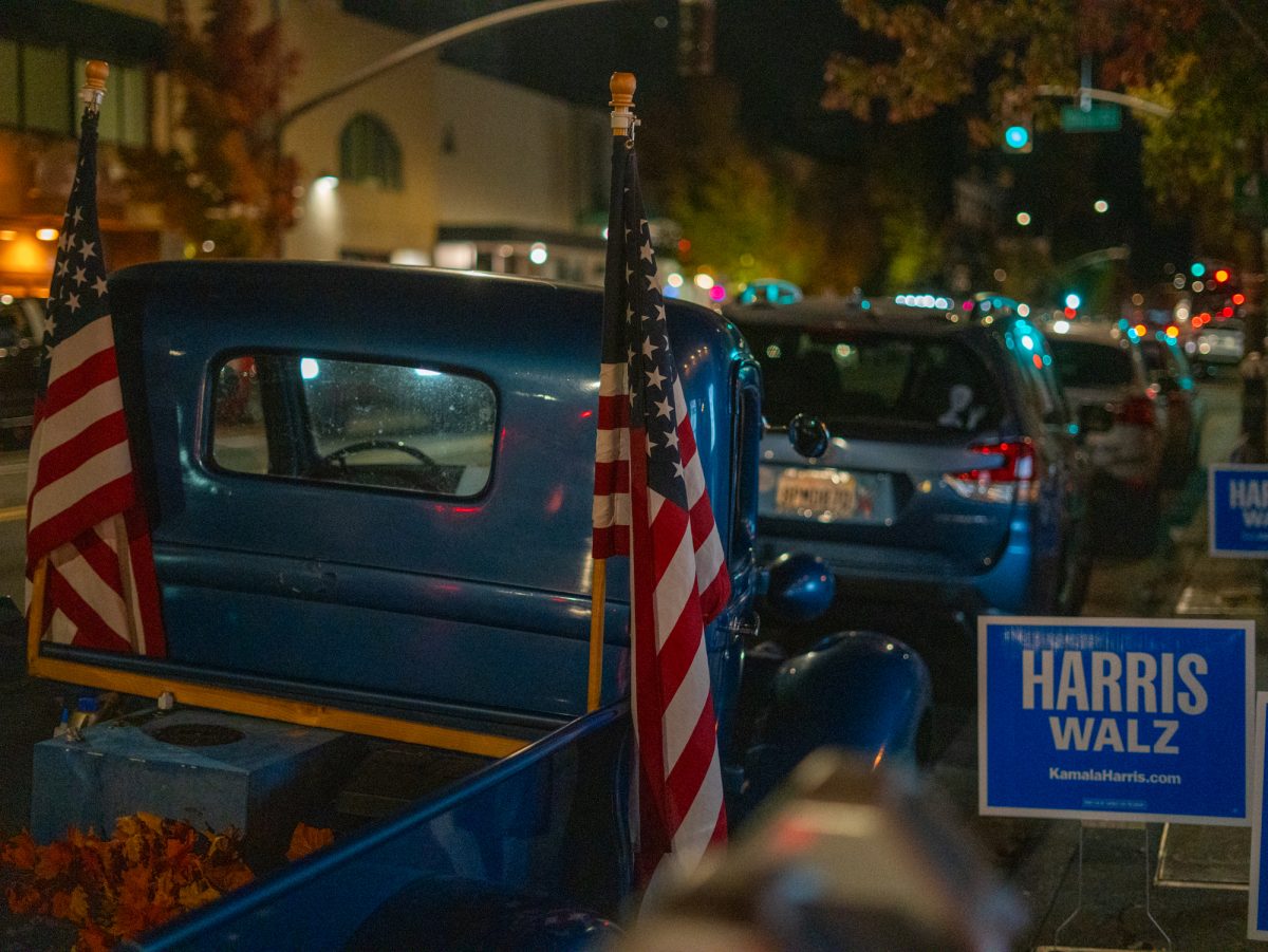 A 'Harris/Walz' sign is displayed right outside of at the Democratic watch party near a patriotically adorned truck at Barrelproof Lounge in Santa Rosa on Tuesday, Nov. 5, 2024.