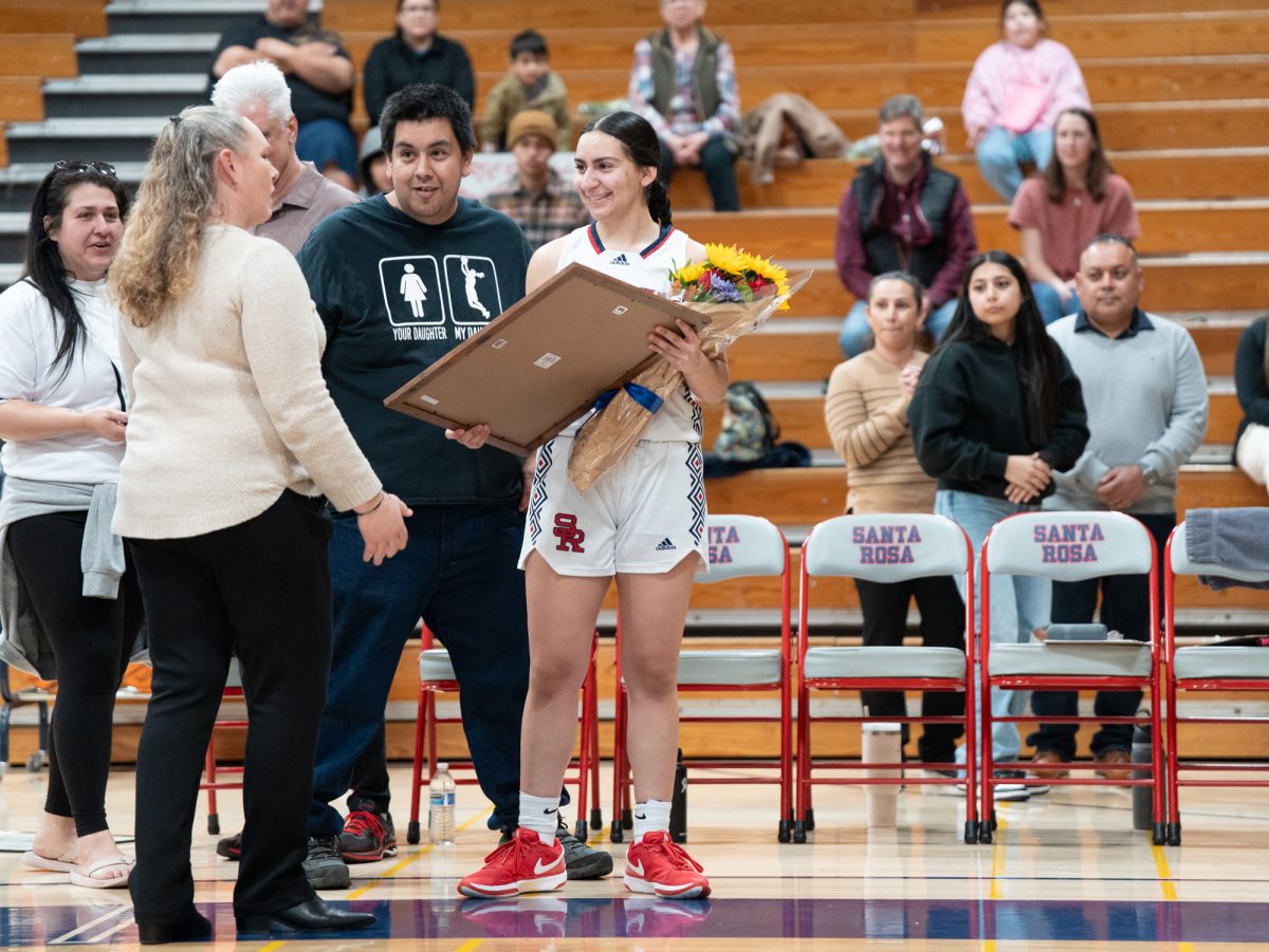 Sophomore forward Cece Solano is presented with a custom picture frame ahead of the game against American River at home on Friday, Feb. 21, 2025.