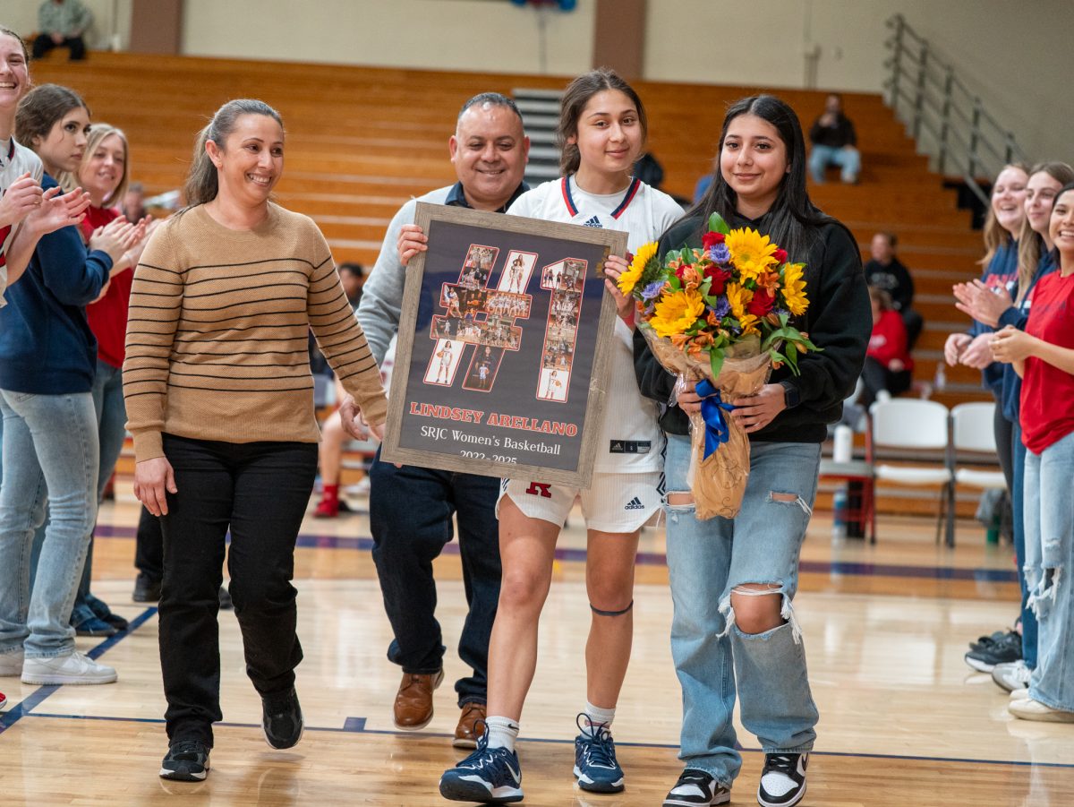 Sophomore guard Lindsey Arellano walks down the tunnel with her loved ones ahead of the game against American River at home on Friday, Feb. 21, 2025.